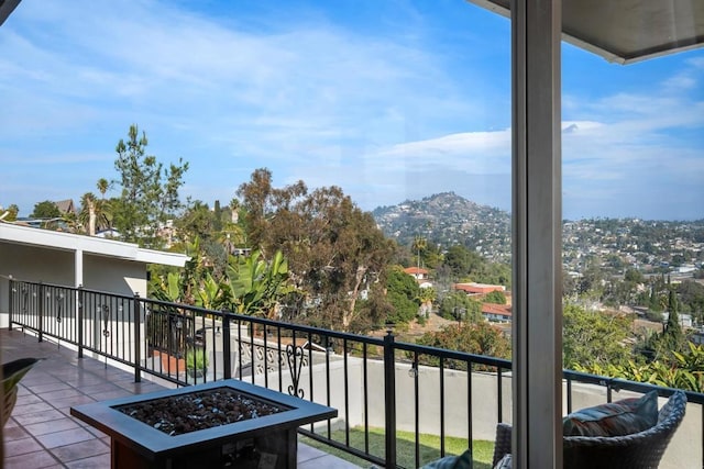 balcony featuring a fire pit and a mountain view