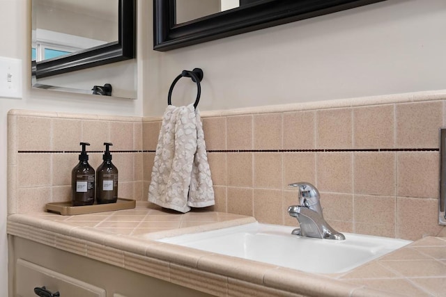 bathroom view of a sink and tasteful backsplash