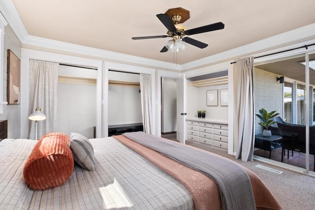 bedroom featuring carpet, two closets, ornamental molding, and ceiling fan
