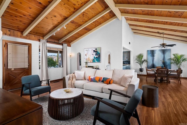 living area with wood finished floors, beamed ceiling, wooden ceiling, arched walkways, and a ceiling fan