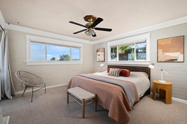carpeted bedroom featuring crown molding, baseboards, and ceiling fan