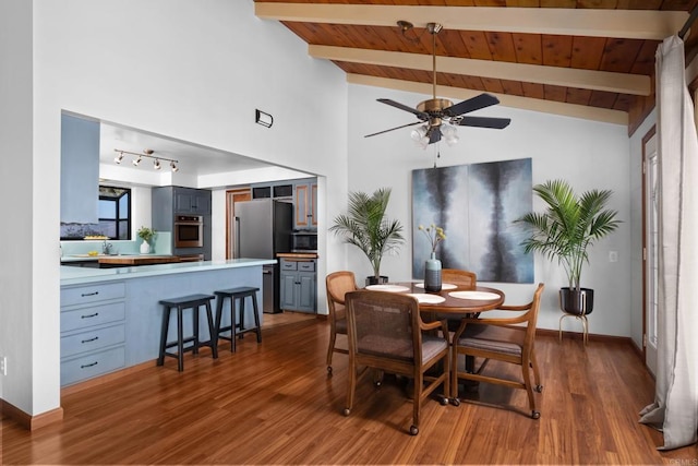 dining room featuring ceiling fan, wood finished floors, wooden ceiling, and baseboards