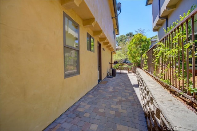 5595 Tanbark Ct, Avila Beach, CA 93424 - view of side of home with stucco siding, central AC, and a patio