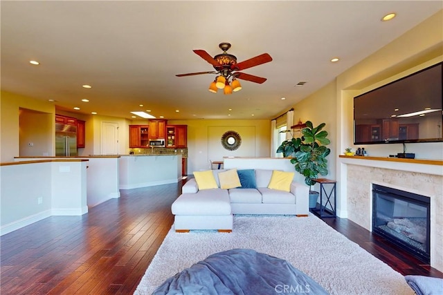 5595 Tanbark Ct, Avila Beach, CA 93424 - living area featuring dark wood finished floors, recessed lighting, a ceiling fan, a glass covered fireplace, and baseboards