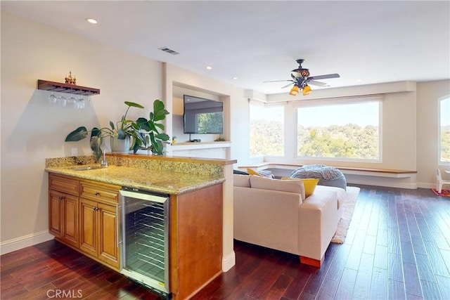 5595 Tanbark Ct, Avila Beach, CA 93424 - kitchen featuring wine cooler, plenty of natural light, dark wood finished floors, light stone countertops, and recessed lighting
