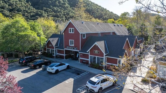 5595 Tanbark Ct, Avila Beach, CA 93424 - view of property featuring uncovered parking and a view of trees