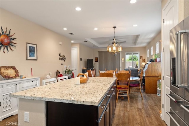 3293 Rogue River Dr, Chico, CA 95973 - kitchen featuring high end fridge, a tray ceiling, dark wood finished floors, a kitchen island, and open floor plan