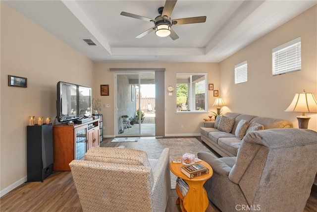 3293 Rogue River Dr, Chico, CA 95973 - living area with a tray ceiling, a ceiling fan, wood finished floors, and baseboards