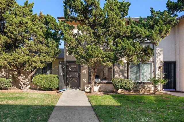 10353 Carefree Dr, Santee, CA 92071 - view of property hidden behind natural elements featuring stucco siding and a gate