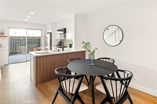 10353 Carefree Dr, Santee, CA 92071 - kitchen featuring freestanding refrigerator, light countertops, white cabinets, light wood-type flooring, and recessed lighting
