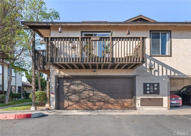 10353 Carefree Dr, Santee, CA 92071 - view of front of house featuring a garage, stucco siding, and a balcony