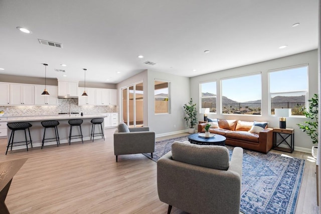 4650 Silent Knoll Dr, Fallbrook, CA 92028 - living area with light wood-style floors, baseboards, recessed lighting, and a mountain view