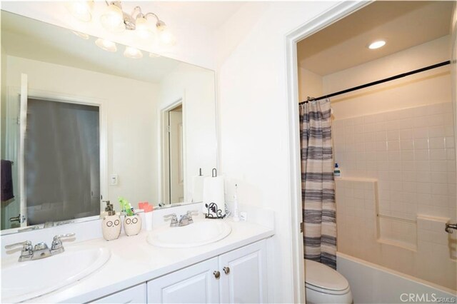 15590 Pumpkin Pl, Fontana, CA 92336 - bathroom featuring toilet, double vanity, and shower / tub combo with curtain