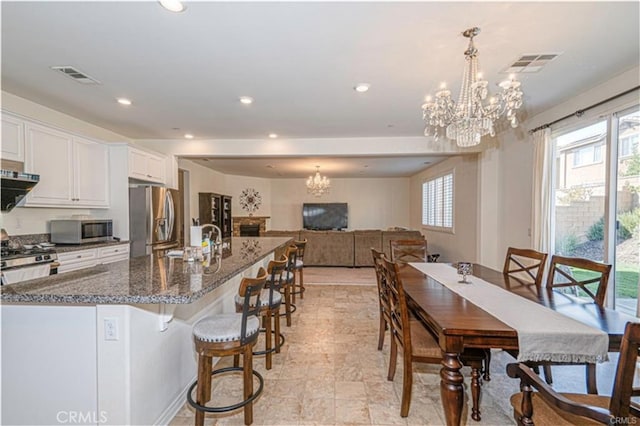 15590 Pumpkin Pl, Fontana, CA 92336 - dining room featuring a chandelier and recessed lighting