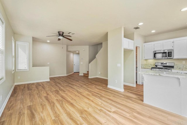 2550 Garnet Peak Rd, Chula Vista, CA 91915 - kitchen with stainless steel appliances, recessed lighting, ceiling fan, light wood-style floors, and white cabinetry