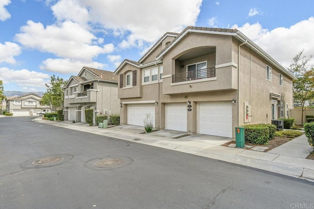 2550 Garnet Peak Rd, Chula Vista, CA 91915 - multi unit property featuring stucco siding, cooling unit, a balcony, and a garage