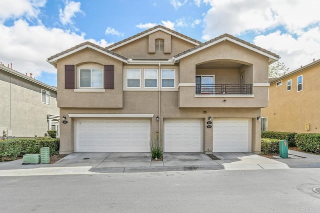 2550 Garnet Peak Rd, Chula Vista, CA 91915 - view of property with stucco siding, an attached garage, a balcony, and concrete driveway