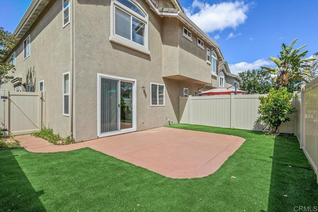2550 Garnet Peak Rd, Chula Vista, CA 91915 - back of property featuring stucco siding, a patio area, and a gate