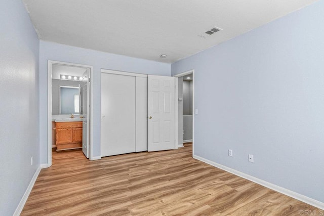 2550 Garnet Peak Rd, Chula Vista, CA 91915 - unfurnished bedroom featuring light wood-style floors, baseboards, a sink, and ensuite bathroom