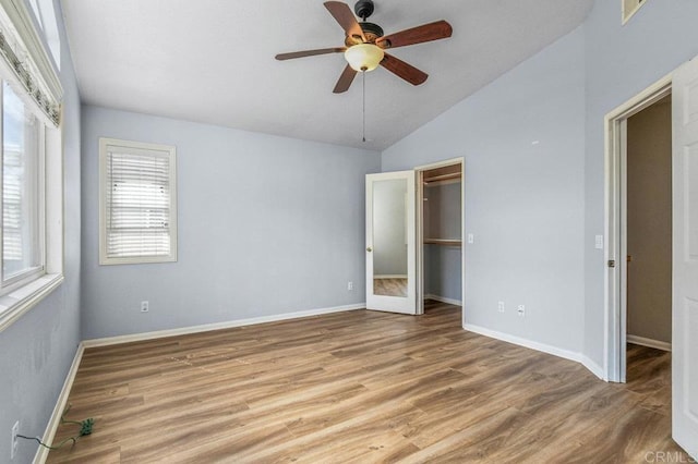 2550 Garnet Peak Rd, Chula Vista, CA 91915 - unfurnished bedroom featuring lofted ceiling, wood finished floors, baseboards, a spacious closet, and a ceiling fan