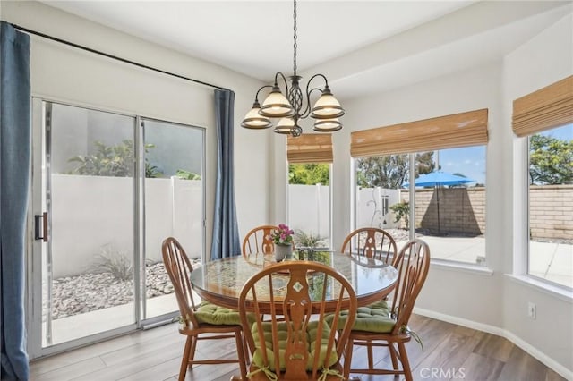 2875 Briarhaven Ln, Corona, CA 92882 - dining area with a chandelier, plenty of natural light, light wood finished floors, and baseboards