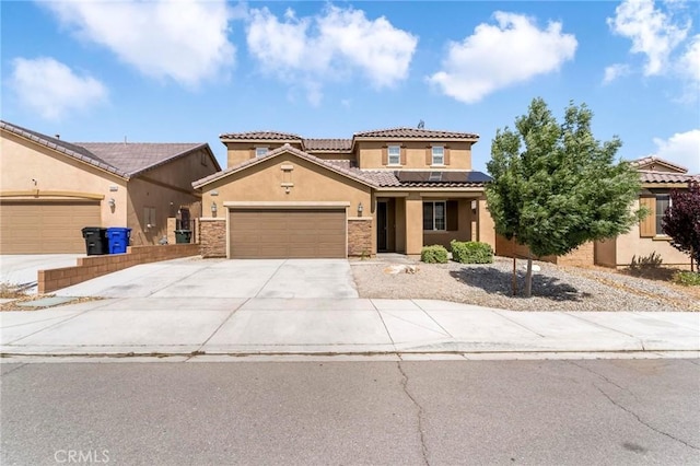 15070 Paseo Verde Pl, Victorville, CA 92394 - view of front of property featuring stucco siding, a tiled roof, an attached garage, solar panels, and driveway