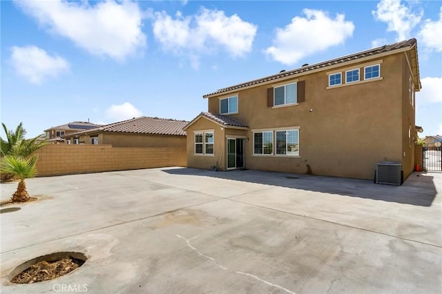 15070 Paseo Verde Pl, Victorville, CA 92394 - rear view of house with a fenced backyard, stucco siding, central AC, a patio, and a tile roof