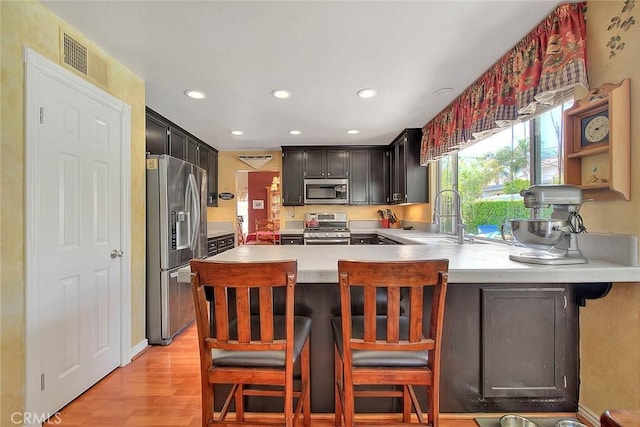6730 Harrington Ct, Chino, CA 91710 - kitchen with stainless steel appliances, a sink, recessed lighting, light countertops, and a peninsula