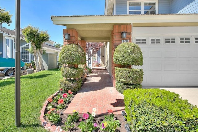 6730 Harrington Ct, Chino, CA 91710 - view of exterior entry featuring an attached garage, a lawn, and driveway