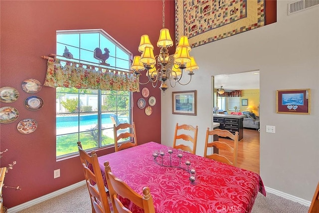 6730 Harrington Ct, Chino, CA 91710 - carpeted dining room featuring a towering ceiling, a chandelier, baseboards, and ceiling fan