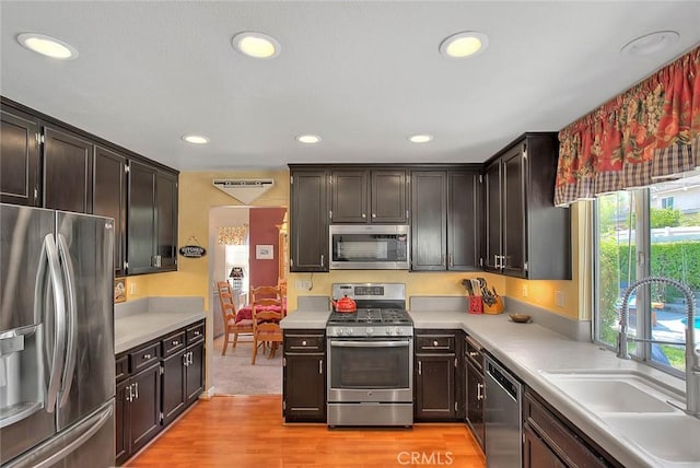 6730 Harrington Ct, Chino, CA 91710 - kitchen with appliances with stainless steel finishes, a sink, light wood-type flooring, light countertops, and recessed lighting