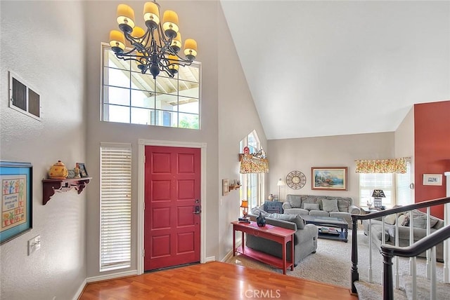 6730 Harrington Ct, Chino, CA 91710 - foyer with high vaulted ceiling, baseboards, a chandelier, wood finished floors, and plenty of natural light