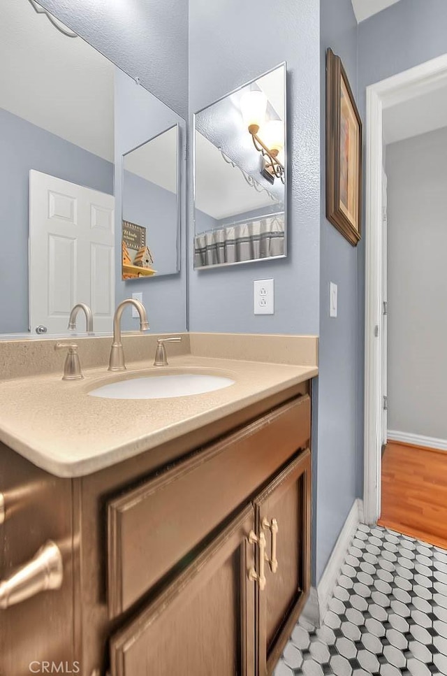 6730 Harrington Ct, Chino, CA 91710 - bathroom featuring vanity and baseboards