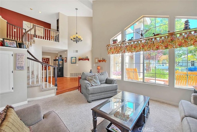 6730 Harrington Ct, Chino, CA 91710 - carpeted living room featuring a chandelier, stairway, healthy amount of natural light, baseboards, and a high ceiling