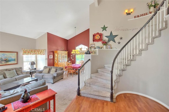 6730 Harrington Ct, Chino, CA 91710 - living area featuring high vaulted ceiling, wood finished floors, stairway, and baseboards