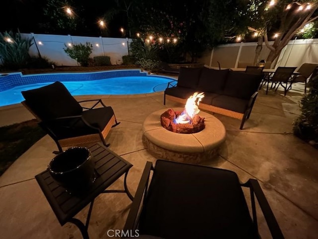 6730 Harrington Ct, Chino, CA 91710 - pool at night with a fenced backyard, a patio, and an outdoor living space with a fire pit