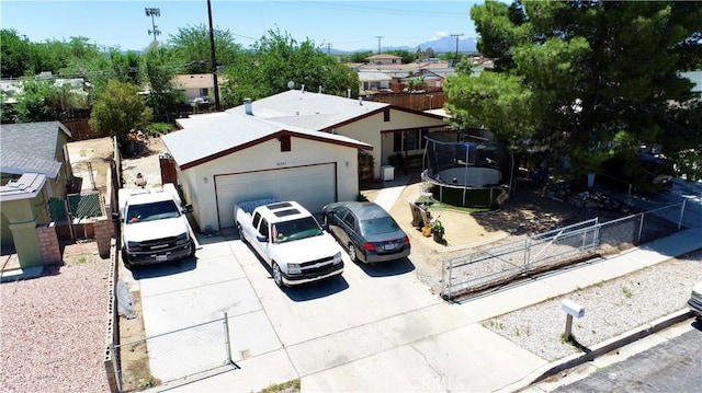 16161 Vallejo St, Victorville, CA 92395 - single story home featuring a trampoline, concrete driveway, an attached garage, a gate, and stucco siding