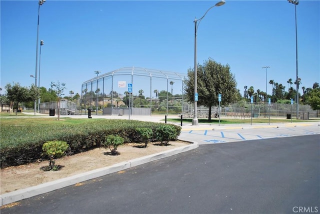 4676 Maxwell Ct, Riverside, CA 92501 - view of asphalt road featuring curbs and street lights