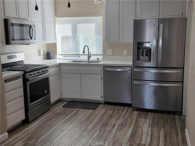 4676 Maxwell Ct, Riverside, CA 92501 - kitchen featuring appliances with stainless steel finishes, light countertops, wood finished floors, and white cabinetry