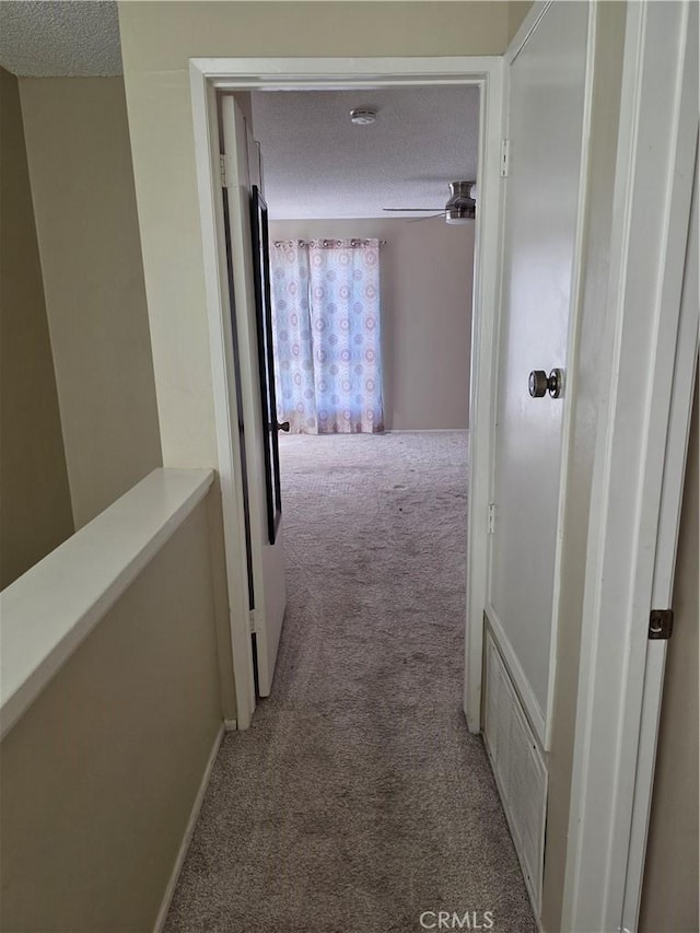 4676 Maxwell Ct, Riverside, CA 92501 - corridor featuring light colored carpet and a textured ceiling