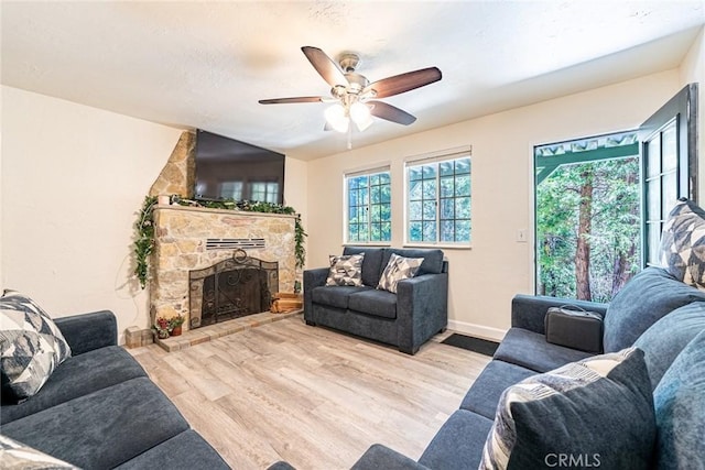 23120 Sycamore Ln, Crestline, CA 92325 - living area featuring wood finished floors, a fireplace, a ceiling fan, and baseboards