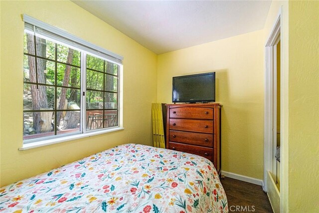 23120 Sycamore Ln, Crestline, CA 92325 - bedroom featuring dark wood-style floors and baseboards