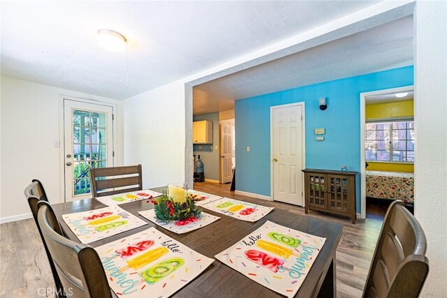 23120 Sycamore Ln, Crestline, CA 92325 - dining area with wood finished floors, healthy amount of natural light, and baseboards