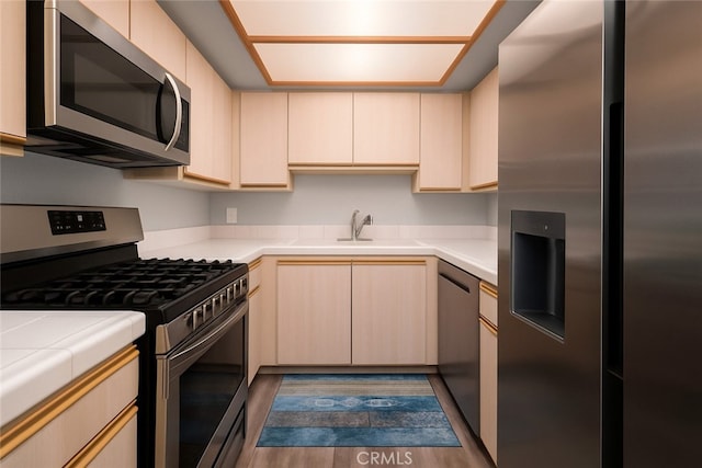 516 Venice Way, Inglewood, CA 90302 - kitchen with appliances with stainless steel finishes, tile counters, light brown cabinetry, and dark wood-type flooring