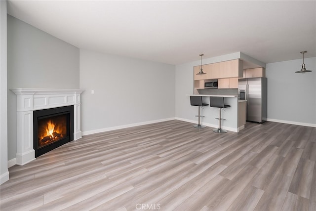 516 Venice Way, Inglewood, CA 90302 - unfurnished living room with light wood-style floors and a lit fireplace