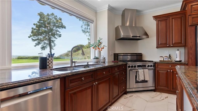kitchen with appliances with stainless steel finishes, wall chimney range hood, a sink, light marble finish floors, and dark stone counters