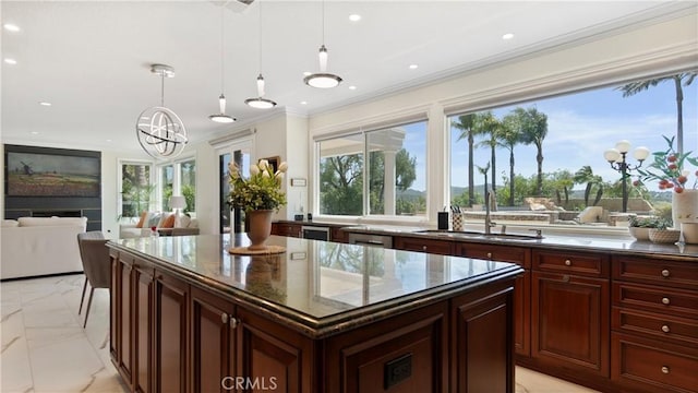 kitchen with light marble finish flooring, a sink, ornamental molding, a chandelier, and pendant lighting