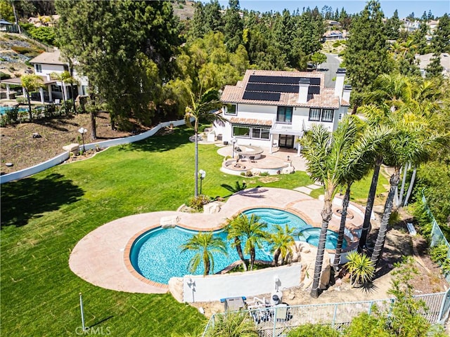 swimming pool with a patio and an in-ground hot tub