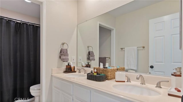 bathroom with toilet, double vanity, and a shower with shower curtain
