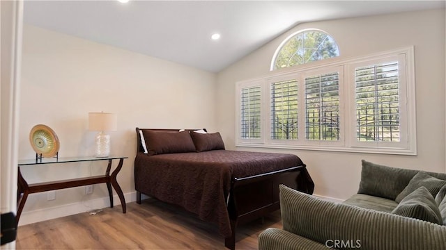 bedroom featuring wood finished floors, vaulted ceiling, baseboards, and recessed lighting